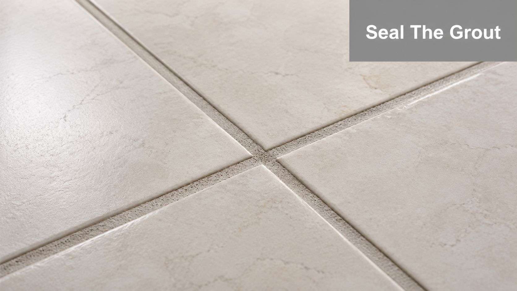 Close-up view of beige ceramic floor tiles with clean, textured grout lines between them.